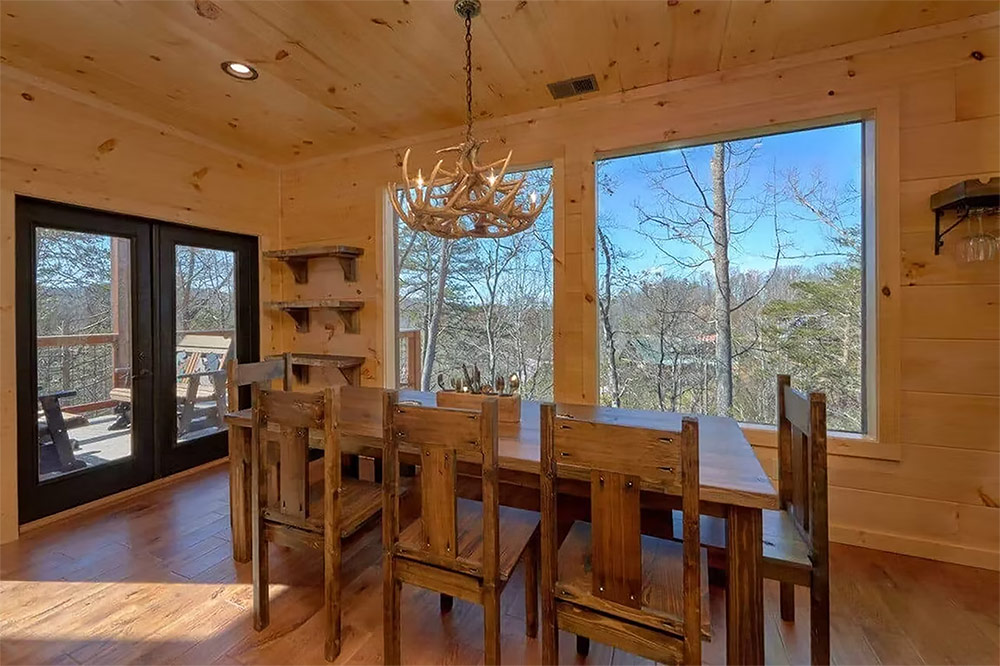 Dining room with panoramic mountain views and vaulted wood ceiling