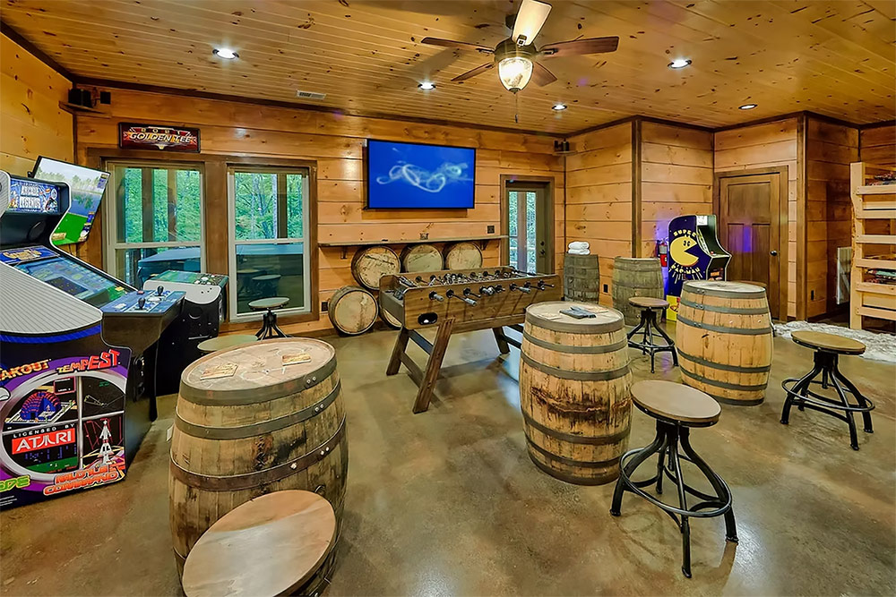 Entertainment room with arcade games and custom bar area