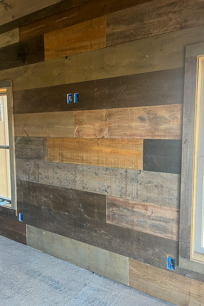 Mixed-width reclaimed wood accent wall inside a custom mountain home