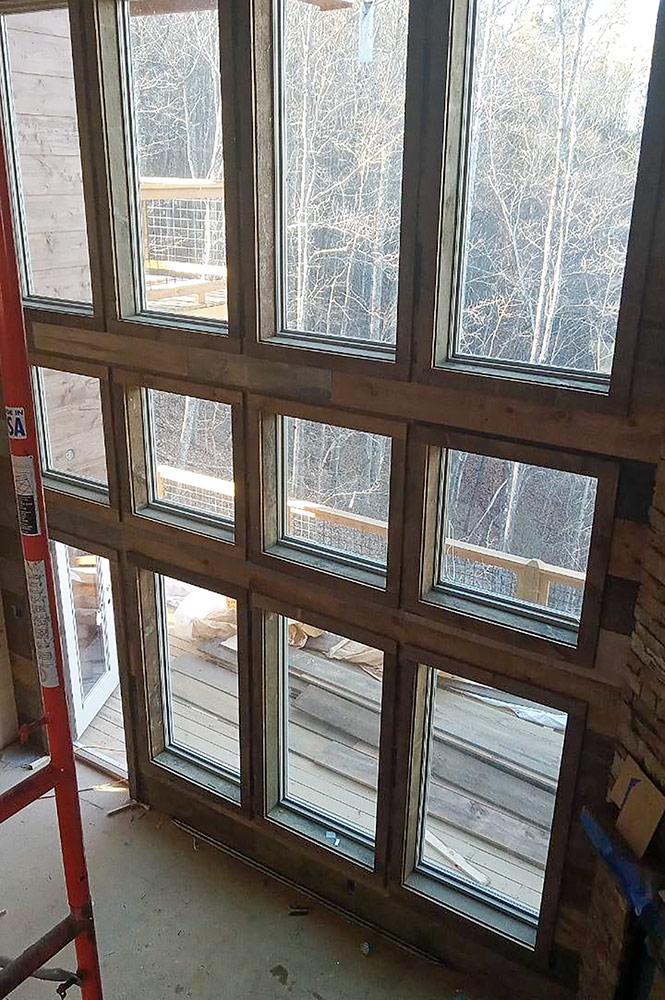 Floor-to-ceiling grid windows installed in a custom mountain home great room