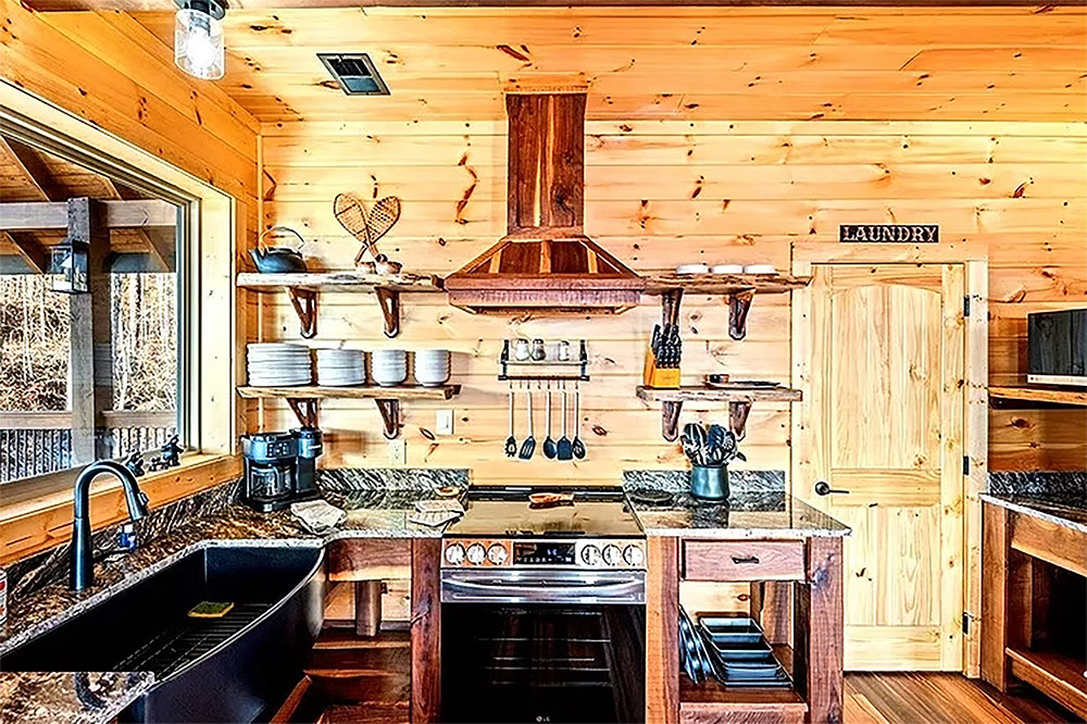 Rustic kitchen featuring custom wood cabinetry and copper range hood