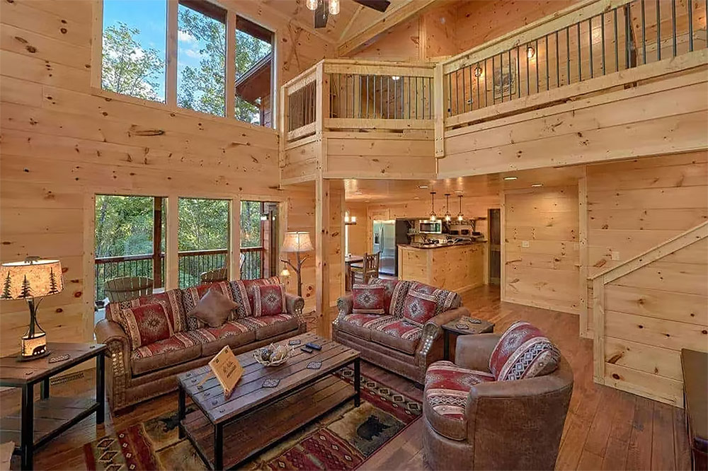 Two-story great room with exposed timber beams and open loft