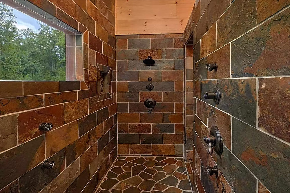 Walk-in tile shower with custom stone finishes