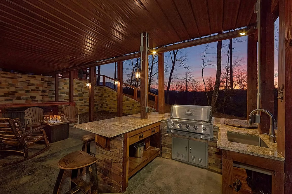 Covered porch with outdoor kitchen and entertainment area