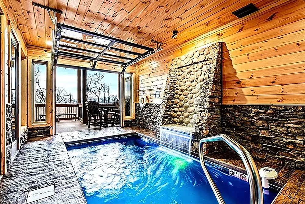 Indoor swimming pool with natural stone finishes