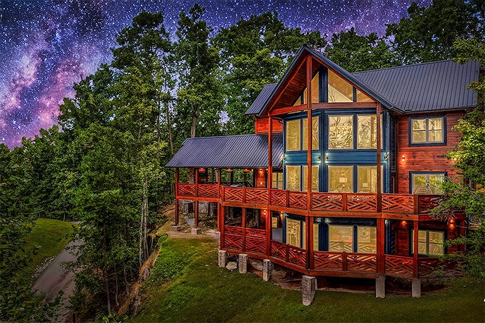 Luxury mountain home with floor-to-ceiling windows and panoramic forest views